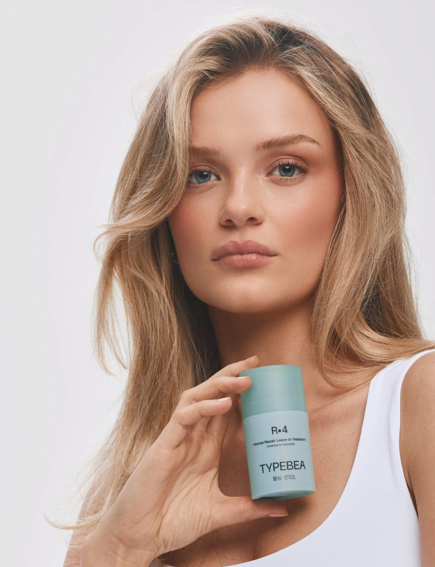 Model holding R&middot;4 Intense Repair Leave-In Treatment